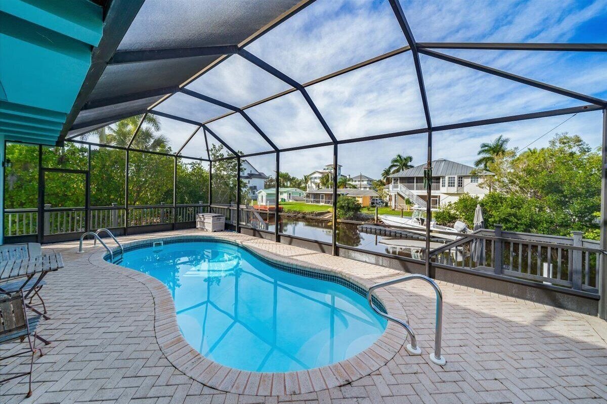 Photo 19 of Adorable canal front cottage close to beach with boat ramp, dock & heated pool.