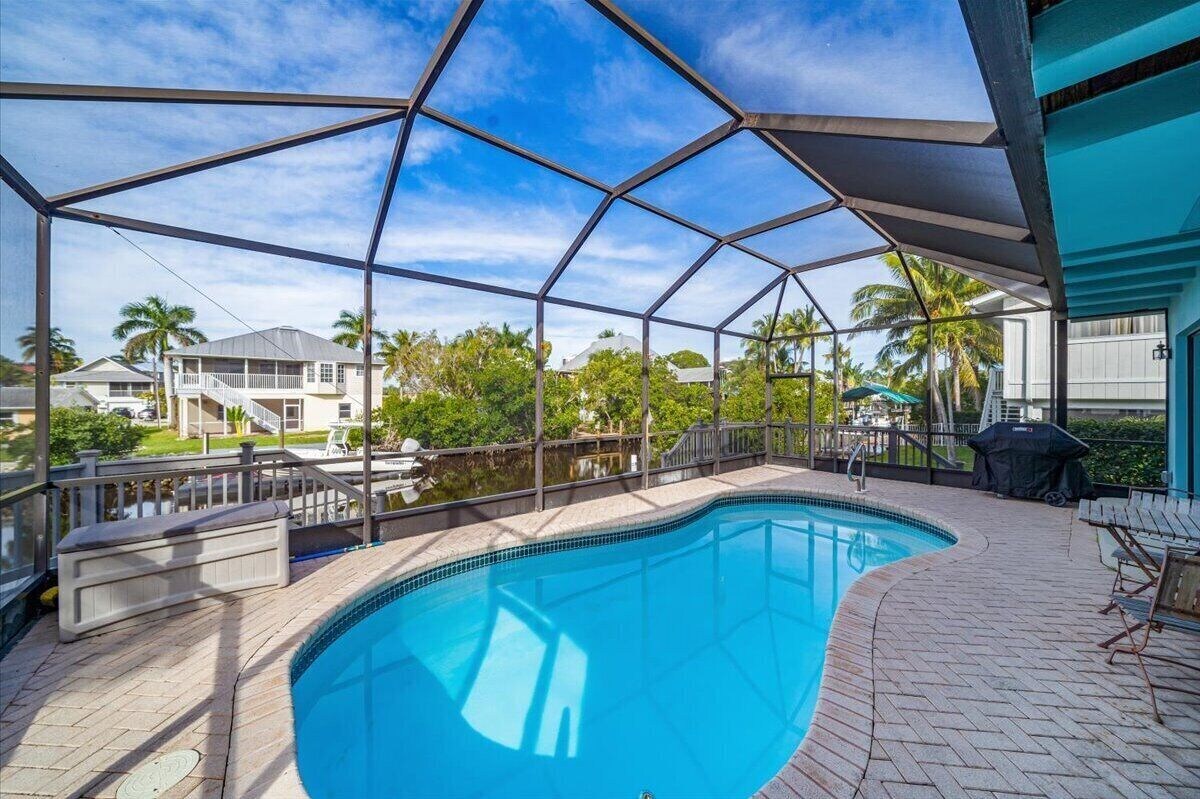 Photo 20 of Adorable canal front cottage close to beach with boat ramp, dock & heated pool.