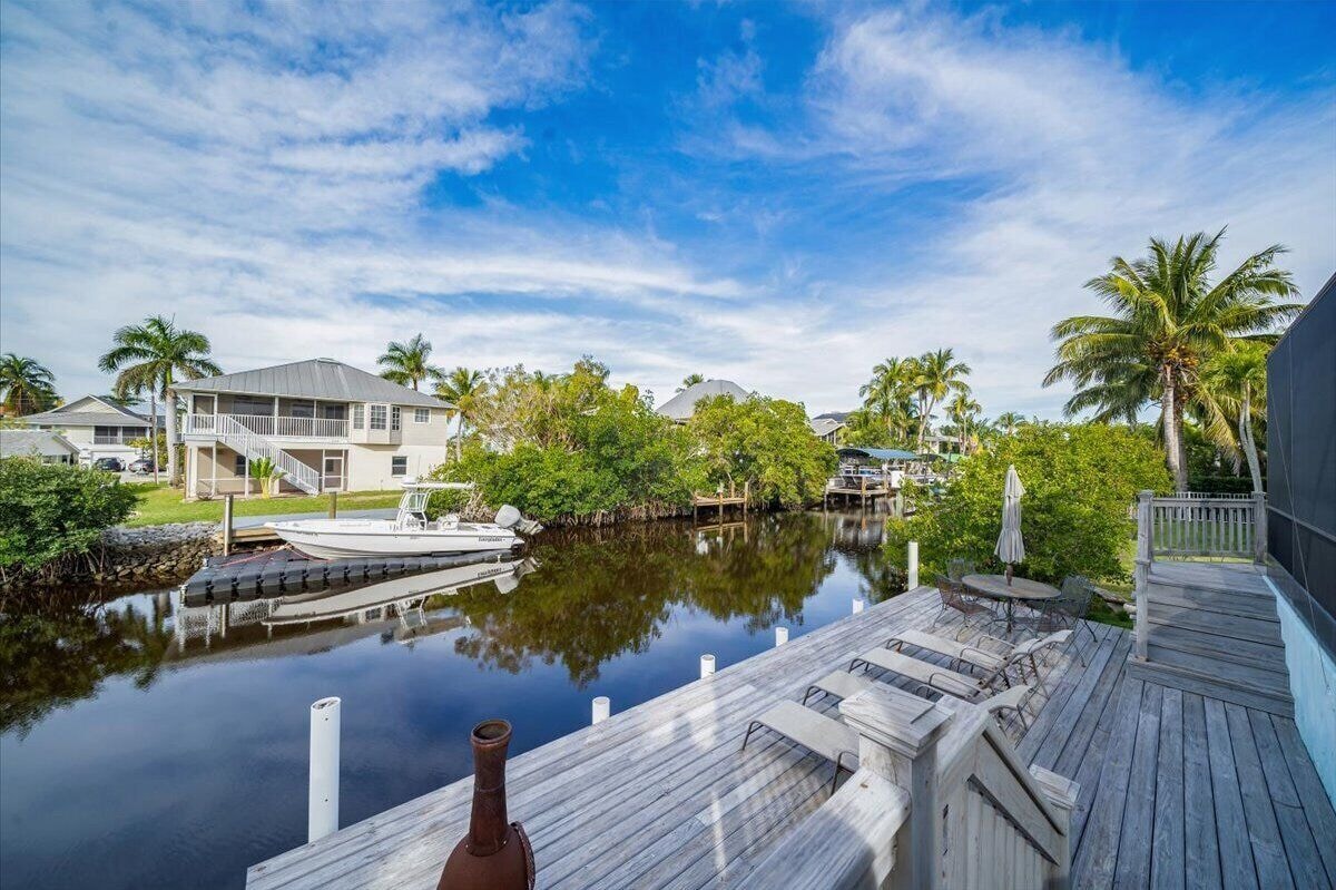 Photo 26 of Adorable canal front cottage close to beach with boat ramp, dock & heated pool.