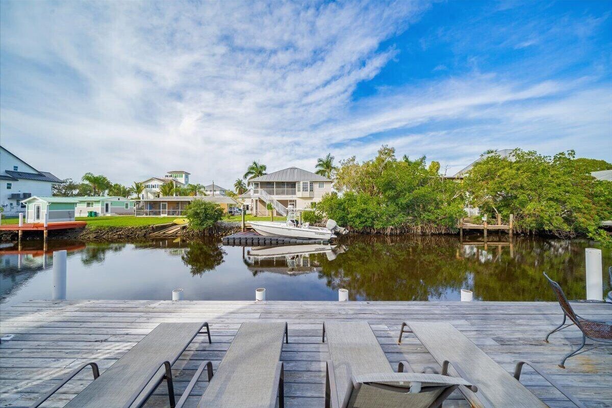 Photo 25 of Adorable canal front cottage close to beach with boat ramp, dock & heated pool.