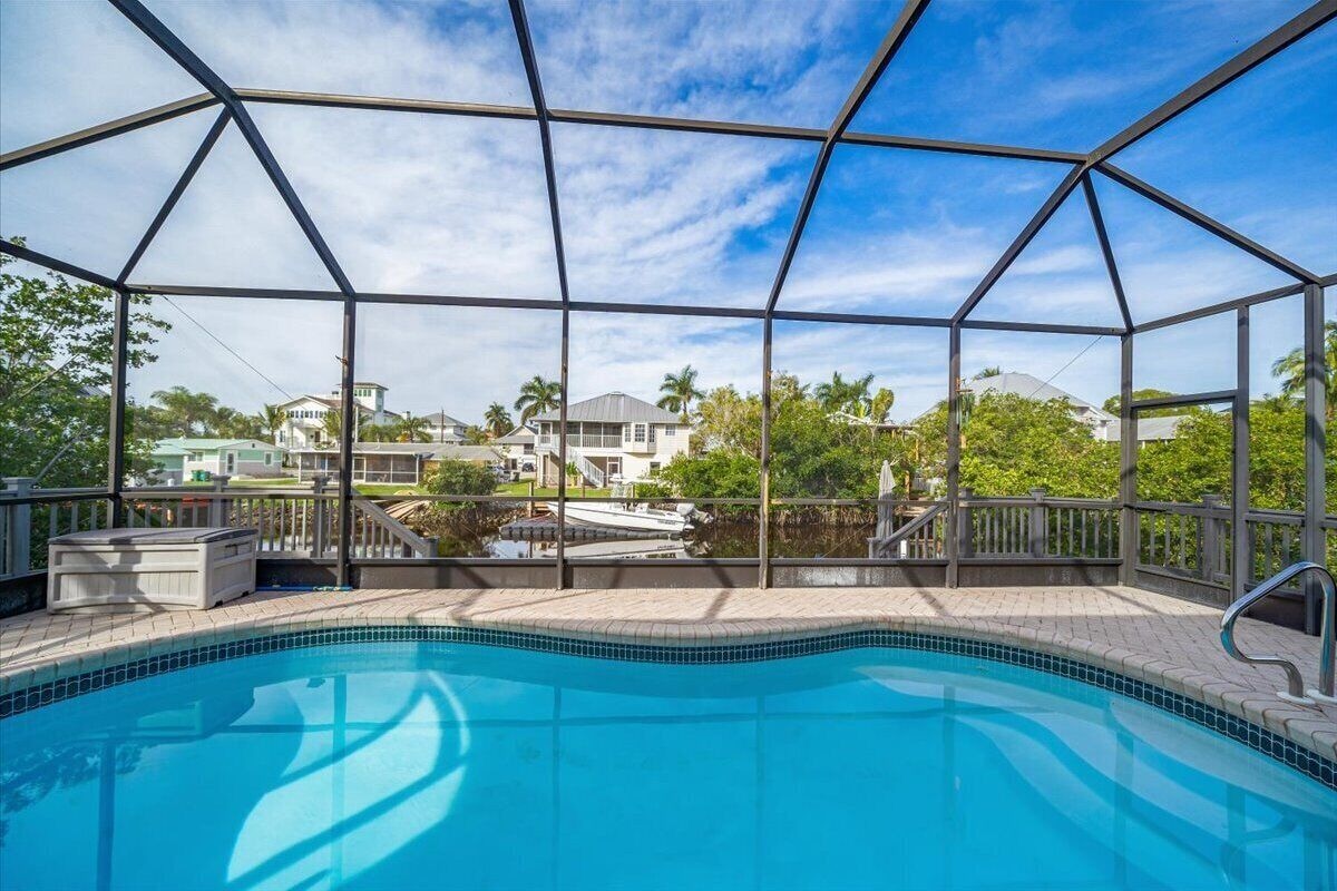 Photo 18 of Adorable canal front cottage close to beach with boat ramp, dock & heated pool.