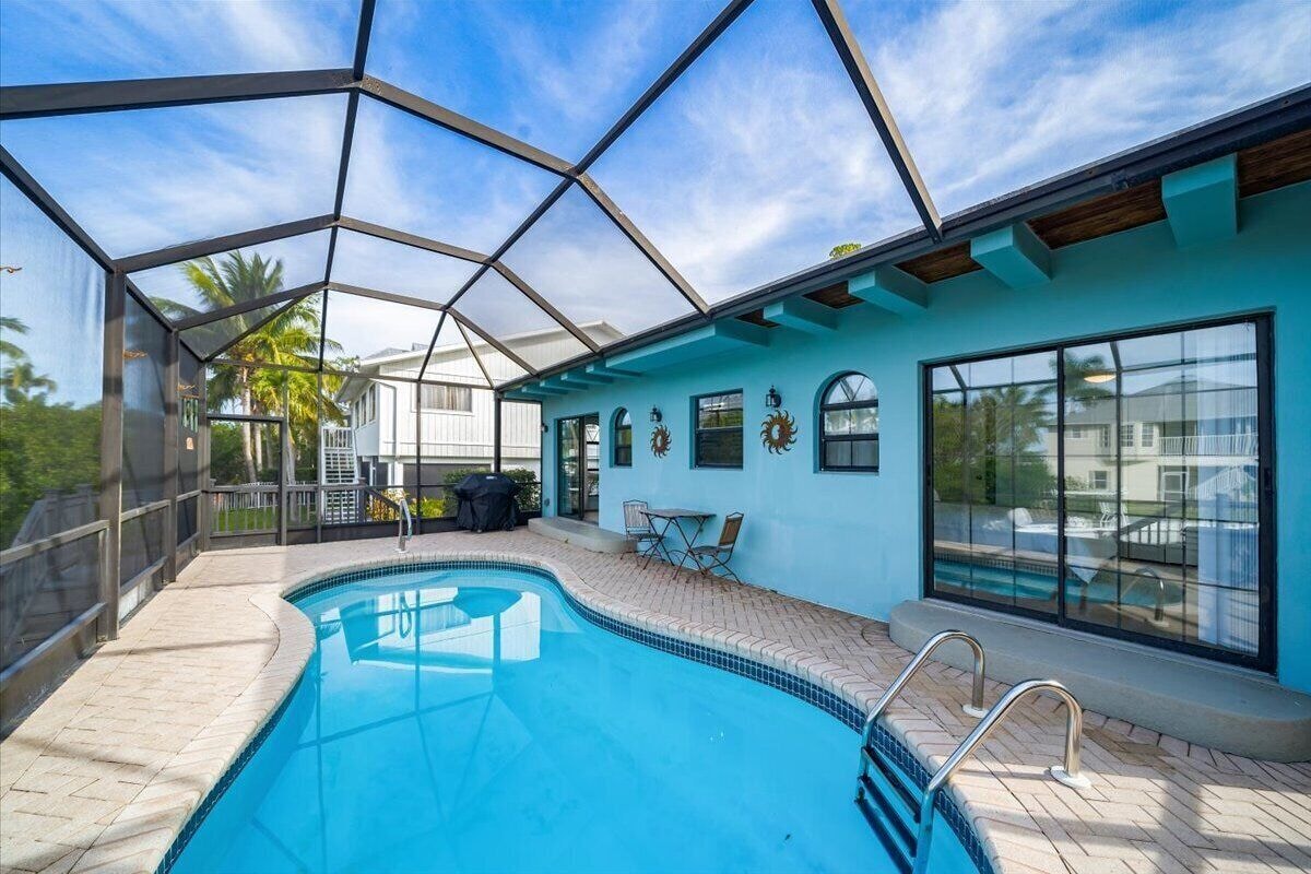 Photo 17 of Adorable canal front cottage close to beach with boat ramp, dock & heated pool.