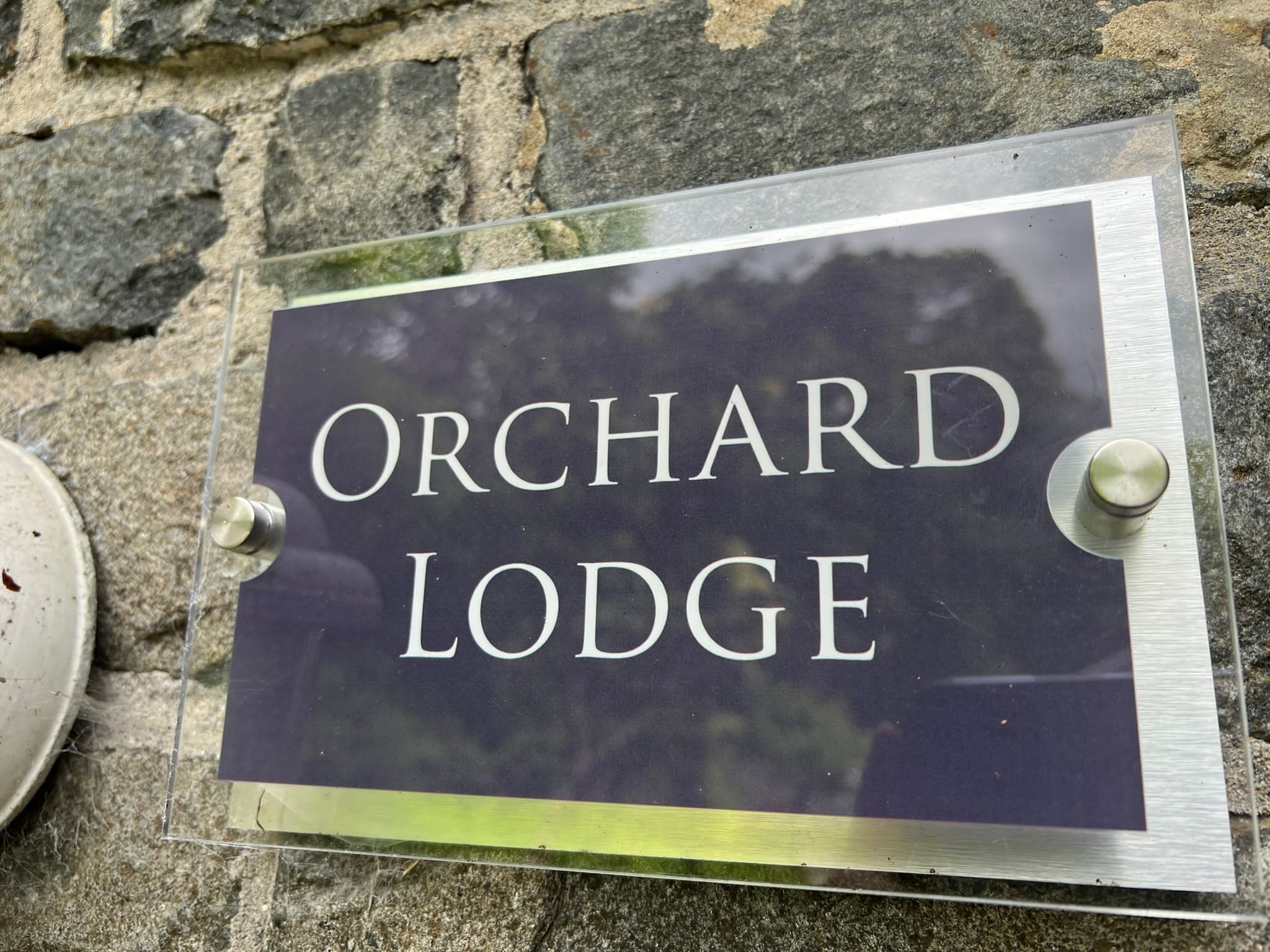 A sign for Orchard Lodge.