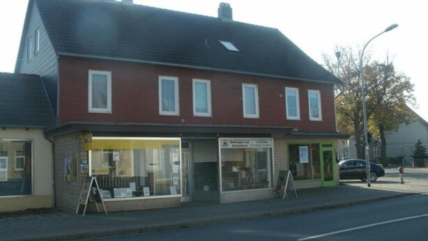 A two-story building with a red facade and multiple windows. - Gästehaus Harz (Goslar)