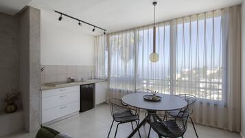 Deluxe Apartment | Minibar, desk, laptop workspace, iron/ironing board