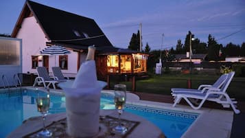 Seasonal outdoor pool, open 11:00 AM to 8:30 PM, pool umbrellas