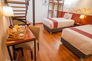 Family Quadruple Room | Minibar, in-room safe, individually decorated, individually furnished