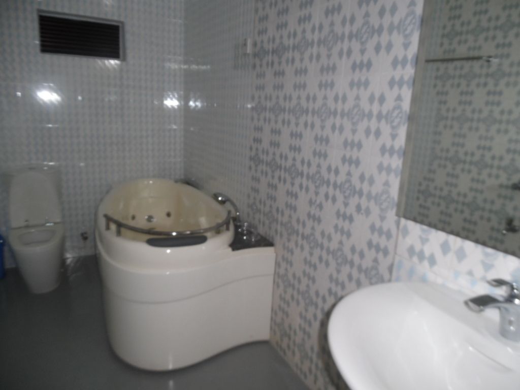A bathroom with a bathtub, toilet, and sink.