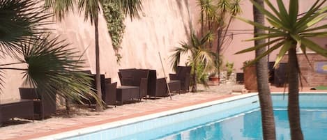 Seasonal outdoor pool, open 9:00 AM to 7:30 PM, pool umbrellas