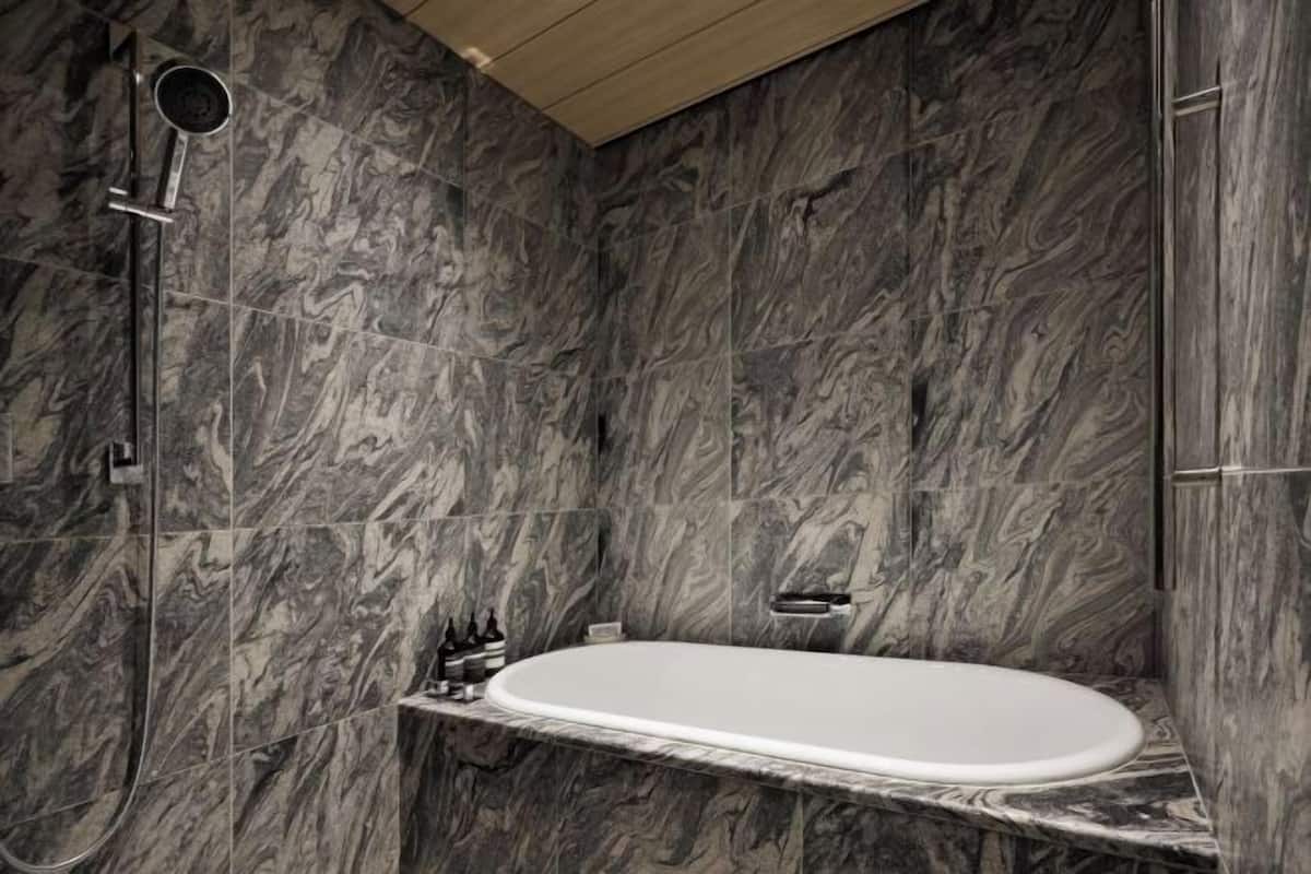 Combined shower/bathtub, deep-soaking bathtub, designer toiletries