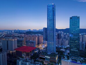 A cityscape with high-rise buildings, a prominent skyscraper, and a large red-roofed structure. - Crowne Plaza Nanning City Center by IHG (Nanning)
