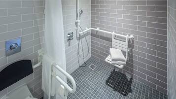 A modern bathroom with a shower, toilet, and grab bars.
