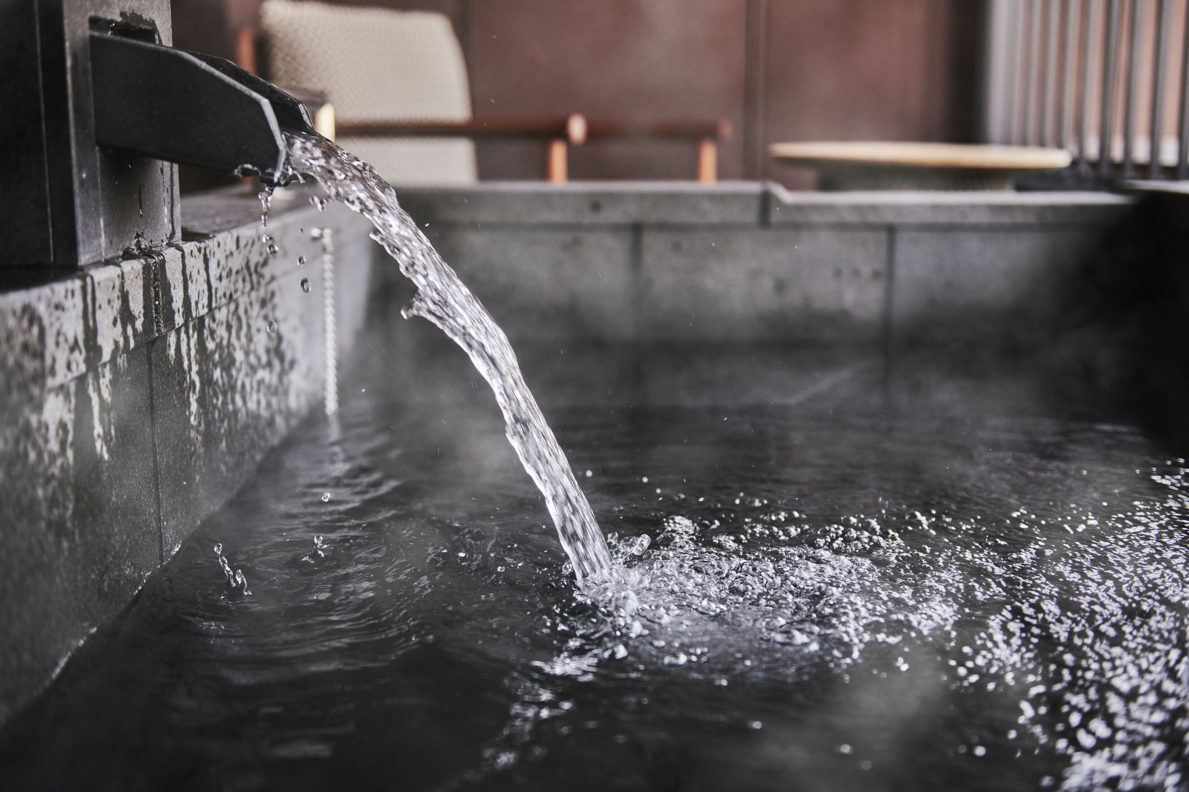 A water feature with a stream flowing into a pool.