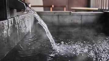 A water feature with a stream flowing into a pool.