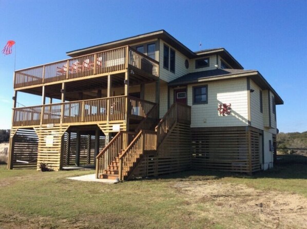 A two-story building with a balcony on the upper floor and a garage on the ground floor.