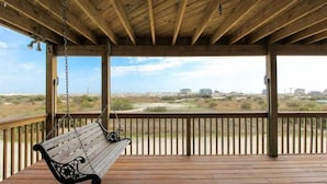 A wooden deck with a hanging bench overlooking a beach landscape. - WHO IS READY FOR SUNSHINE AND SAND?!  PACK YOUR SENSE OF ADVENTURE & COME VISIT! (Corolla)