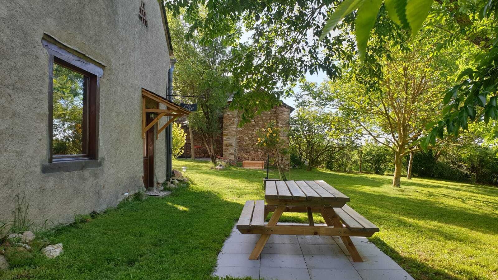 A rustic building with a stone wall and a wooden door.