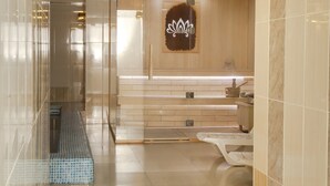 Ein modernes Badezimmer mit einer Duschkabine aus Glas, einem Waschtisch mit Spiegel und einer Wand mit Holzverkleidung.