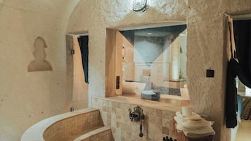 Deluxe Stone Suite with Stone | Bathroom | Deep soaking tub, rainfall showerhead, designer toiletries, hair dryer