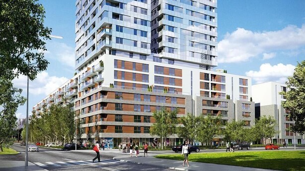 A modern multi-story building with a mix of glass and wood facade, featuring balconies and a pedestrian-friendly street in front.