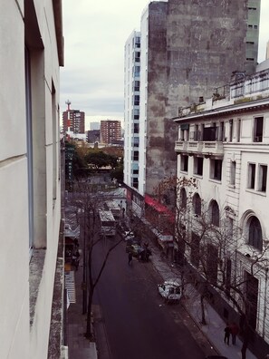 A street view with a hotel named "LUEY HOTEL" and a tall building in the background. - Hotel Lua (Buenos Aires)