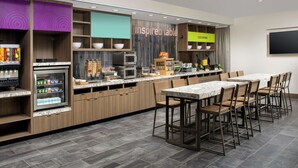 A modern kitchen with a marble countertop, wooden cabinets, and a built-in refrigerator.