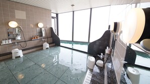 A modern bathroom with a large mirror, a sink, and a toilet. - Sea Aiga Kaigetsu (Sumoto)