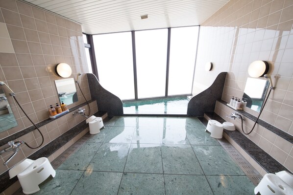 A modern bathroom with two sinks, two toilets, and a large window providing natural light. - Sea Aiga Kaigetsu (Sumoto)