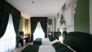 A hotel room with two beds, a desk, a chair, and a television. - Hotel Gradisca (Rimini)