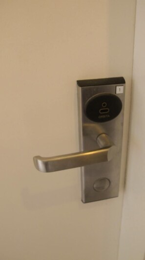 A modern door with a digital lock and a keyhole.