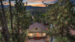 A house surrounded by tall pine trees with a clear view of the mountains in the background. - View Point - Hot Tub, Pool Table, Arcade Game, Slope Views (Big Bear Lake)