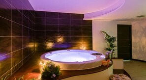 A modern spa room with a hot tub, dark tiled walls, and ambient lighting. - RESIDENTIAL APARTMENT WITH SOLARIUM AND POOL IN THE COMPLEX (PIETRA LIGURE)