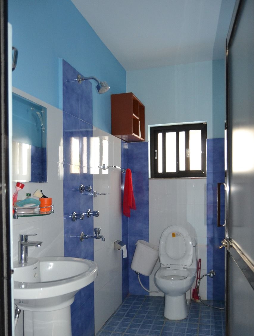 A bathroom with a sink, toilet, and shower.