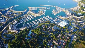 An aerial view of a marina with numerous boats docked, surrounded by residential buildings and greenery. - New- Beach 2min, Direct accès marina, 2km from Saint-Tropez (Les marines de Cogolin)