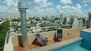 A rooftop pool with two lounge chairs and a view of a cityscape. - LUXURY DUPLEX, fully equipped, 2Bd, pool & terrace (Palermo)