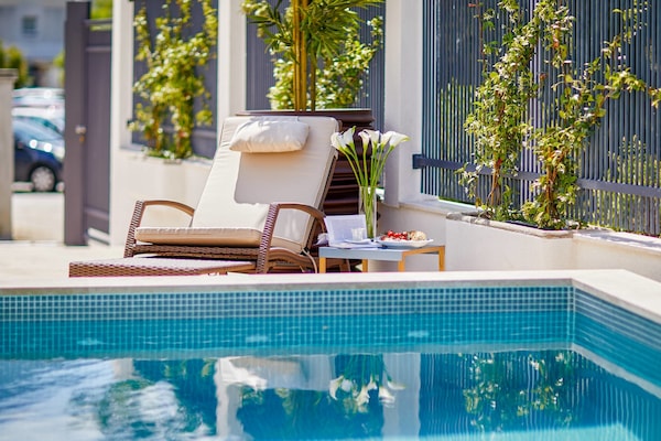 Una piscina al aire libre de temporada, sillones reclinables de piscina