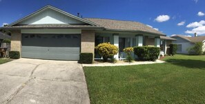 A single-story house with a garage, a front porch, and a well-maintained lawn.