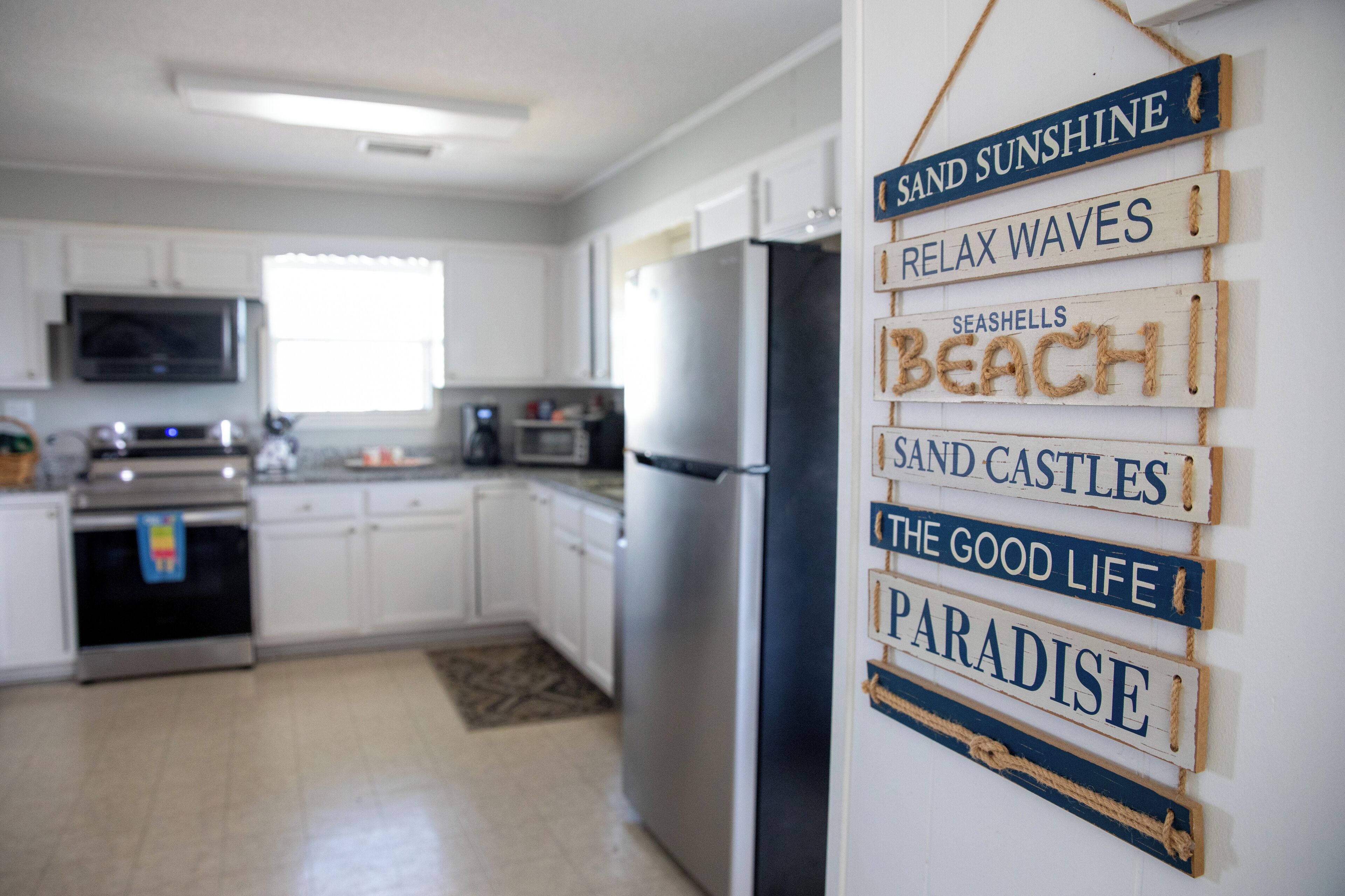 A kitchen with white cabinets and stainless steel appliances.