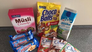 Various food items including a box of Crownfield Musli Crunchy, Choco Balls, Croissant, and Goody Overture cereal.