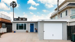 A modern two-story house with a garage, a blue door, and a number 1417 on the garage door. - 1417G - "After Dune Delight" (Ventura)