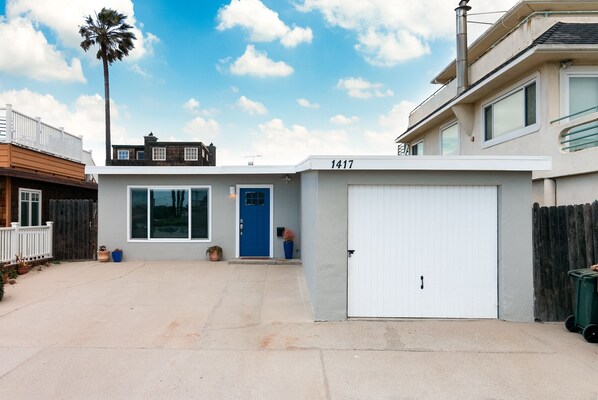 A modern two-story house with a garage, a blue door, and a number 1417 on the garage door. - 1417G - "After Dune Delight" (Ventura)