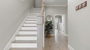 A staircase with white steps and wooden railings, leading to a landing with a potted plant. - Direct Unobstructed GULF VIEWS, Literally Across the St from the Beach! (Panama City Beach)