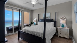 A four-poster bed with a view of the ocean through a sliding glass door. - 1107-11th Floor-BEACH CHAIRS & UMBRELLA INCL-Outdoor Pool-AMAZING BEACH  VIEW! (Panama City Beach)