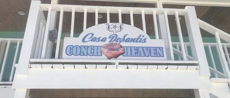 Une enseigne pour Casa DeSantis CONCH Heaven, avec un logo représentant un coquillage.