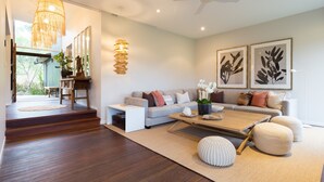 A modern living room with a sofa, coffee table, and decorative plants. - Luxurious retreat in Pullenvale (Pullenvale)