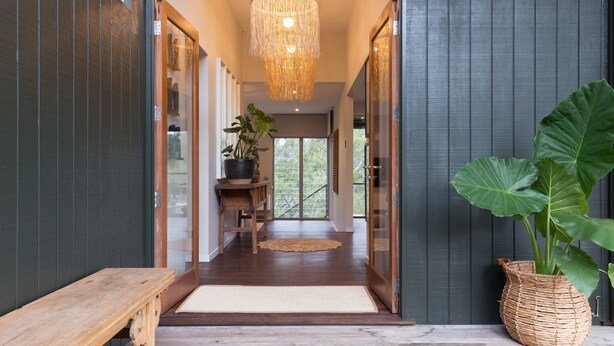 A modern interior with a wooden bench, a woven basket with a plant, and a hanging light fixture. - Luxurious retreat in Pullenvale (Pullenvale)