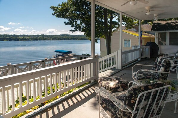 Relax by the lake with a barbecue grill and comfortable seating.