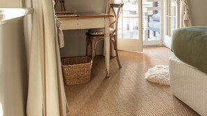 A room with a desk, chair, wicker basket, and a bed. - Arkaba Homestead (Hawker)