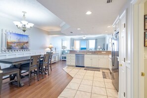 Enjoy meals in the kitchen with a central island, sink, and refrigerator, and dine in the adjacent area with a table and chairs.