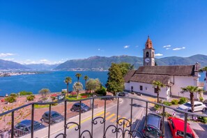 A coastal town with a prominent church, a clear blue sky, and a view of the sea.